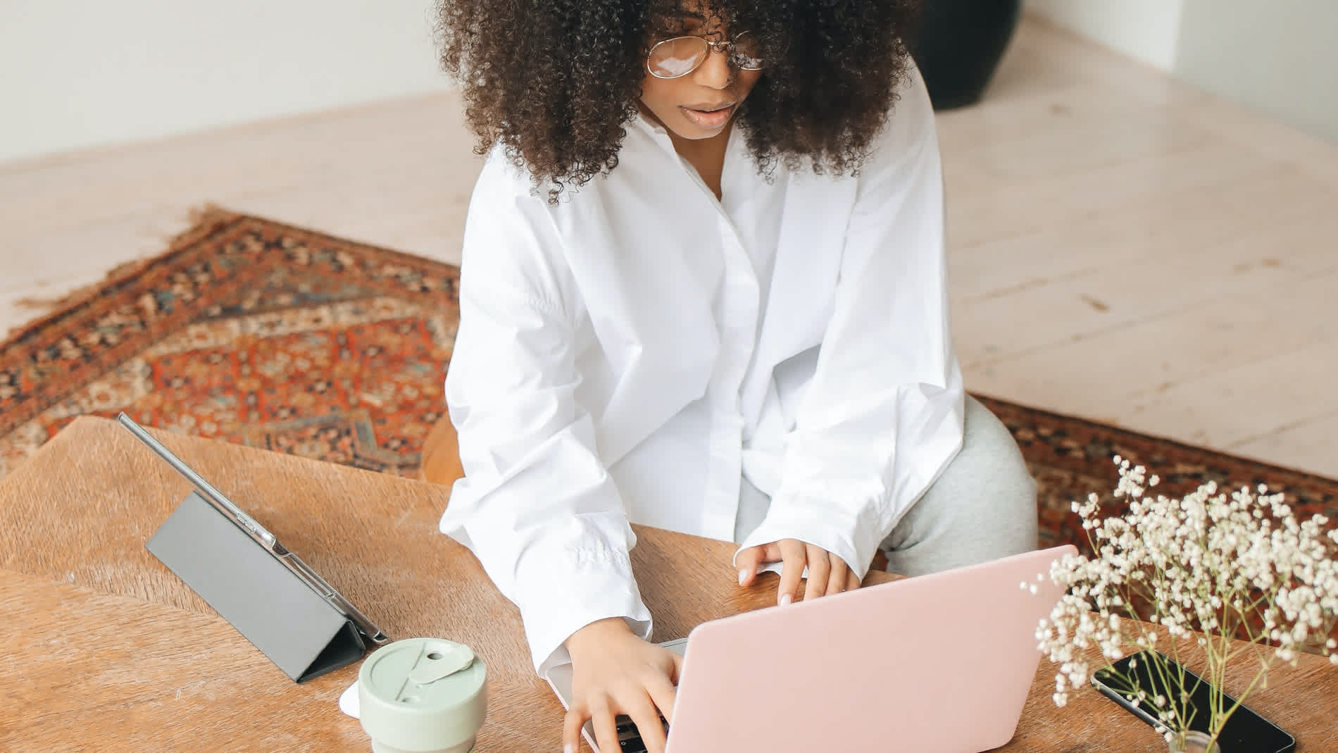 A young woman works on her laptop.